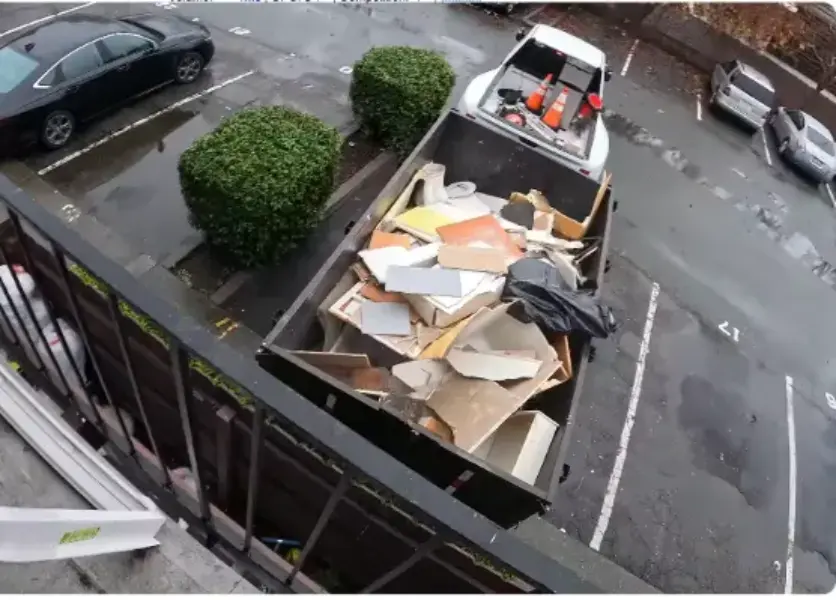 Commercial dumpster filled with cardboard and packaging waste in Fresno, CA