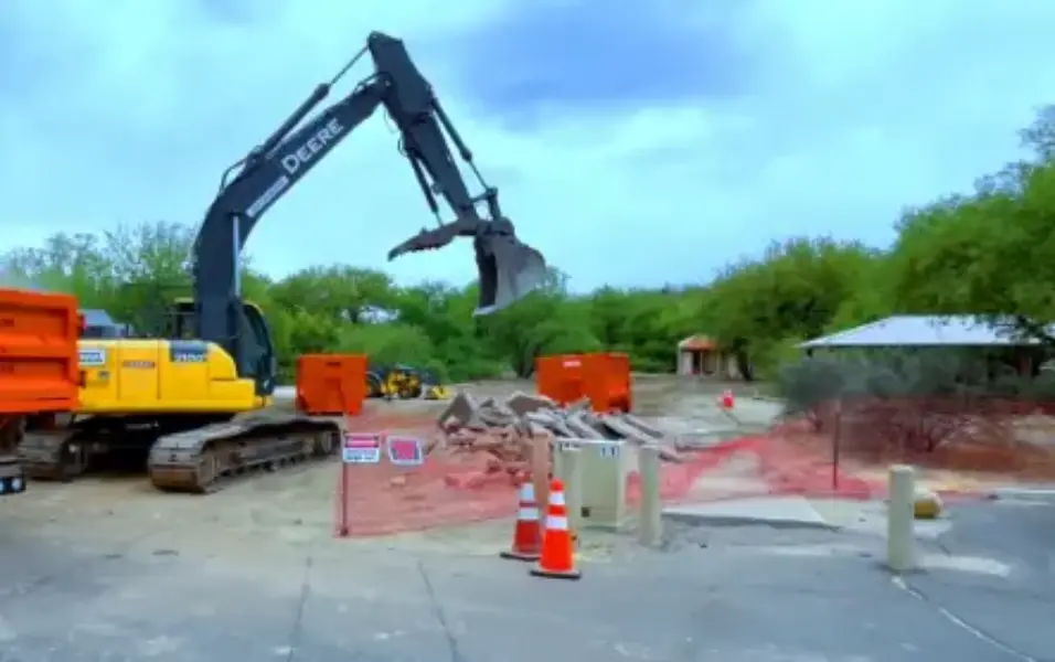 Dumpster rental Fresno crew clearing concrete demolition debris for haul-away