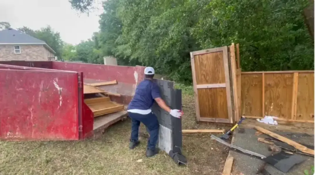 Fence and shed demolition debris loaded into a dumpster in Fresno, CA