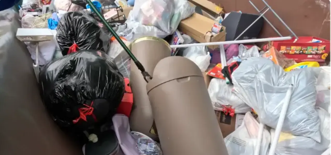 Residential cleanout dumpster full of household debris in Fresno, CA