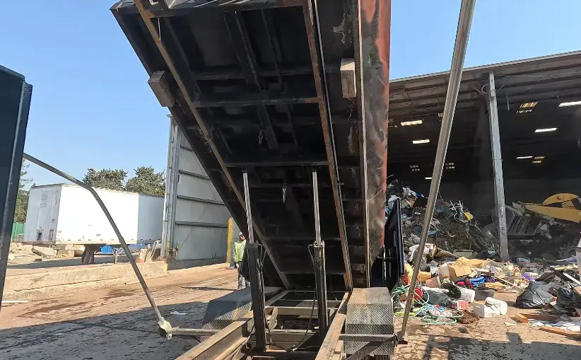 Dumpster rental Fresno crew picking up a full roll-off container